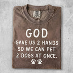 Brown t-shirt with text "GOD GAVE US 2 HANDS SO WE CAN PET 2 DOGS AT ONCE."