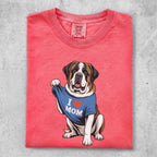 St. Bernard dog wearing a blue "I MOM" t-shirt.