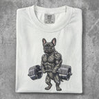 Muscular French bulldog lifting weights on a white t-shirt.