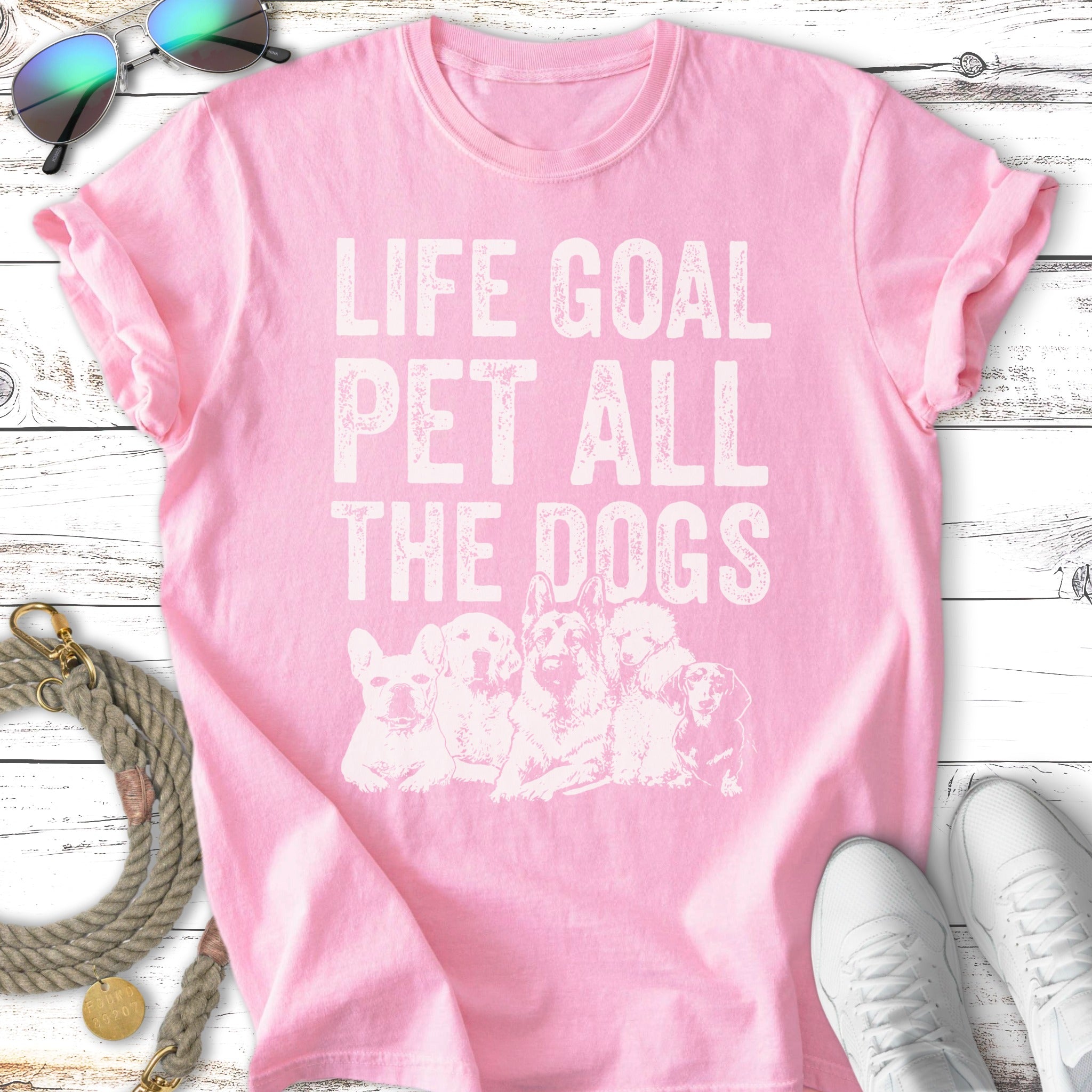 Pink t-shirt with "Life Goal Pet All The Dogs" text and dog illustrations.