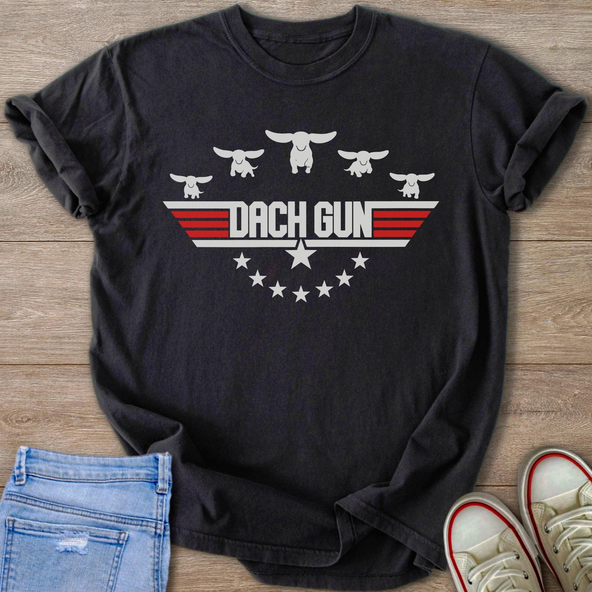 Black t-shirt with "DACH GUN" text, stylized dachshunds, and stars.