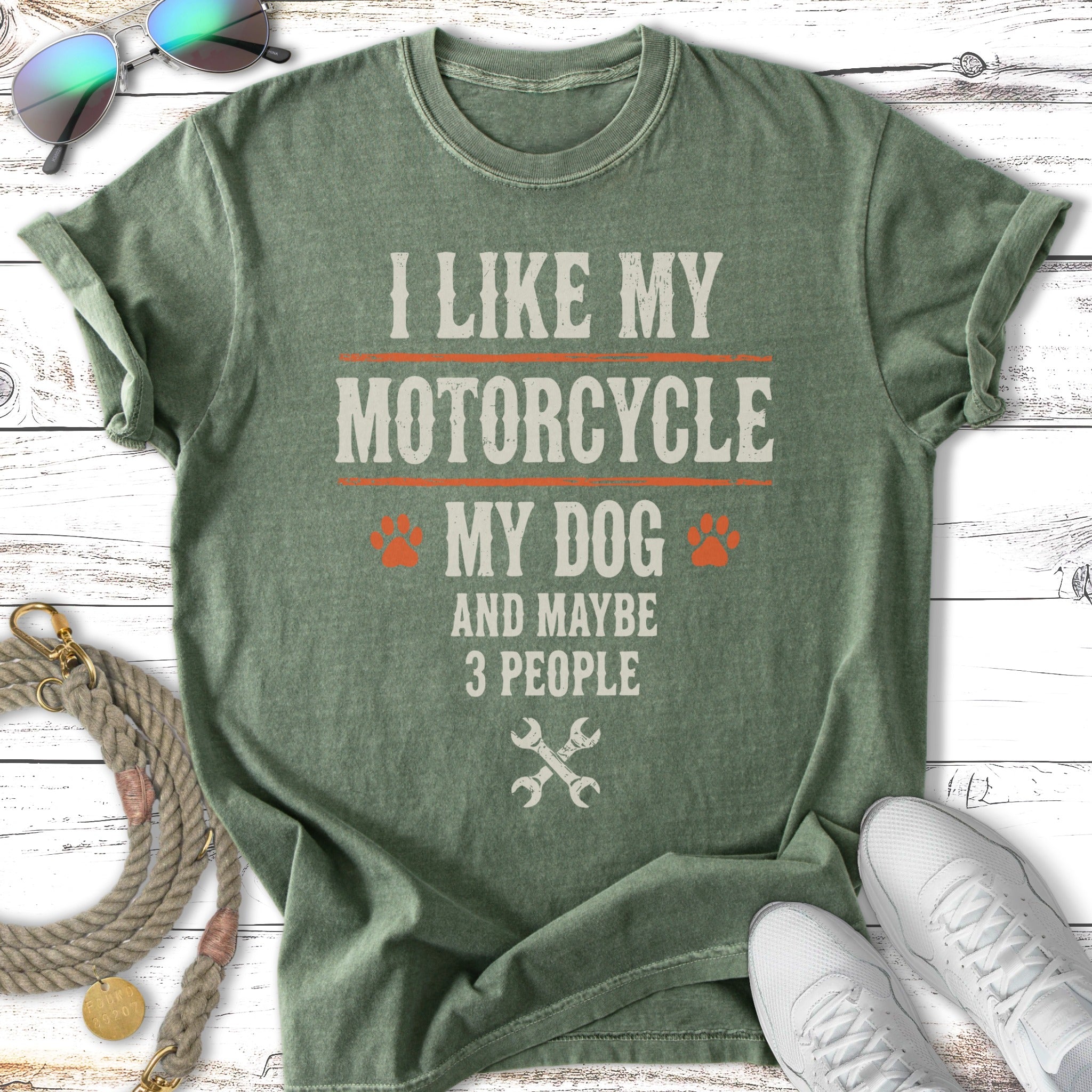 Green t-shirt with "I like my motorcycle, my dog and maybe 3 people" text.