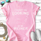 Pink t-shirt with a dachshund graphic and "I caught you looking at my weiner" text.