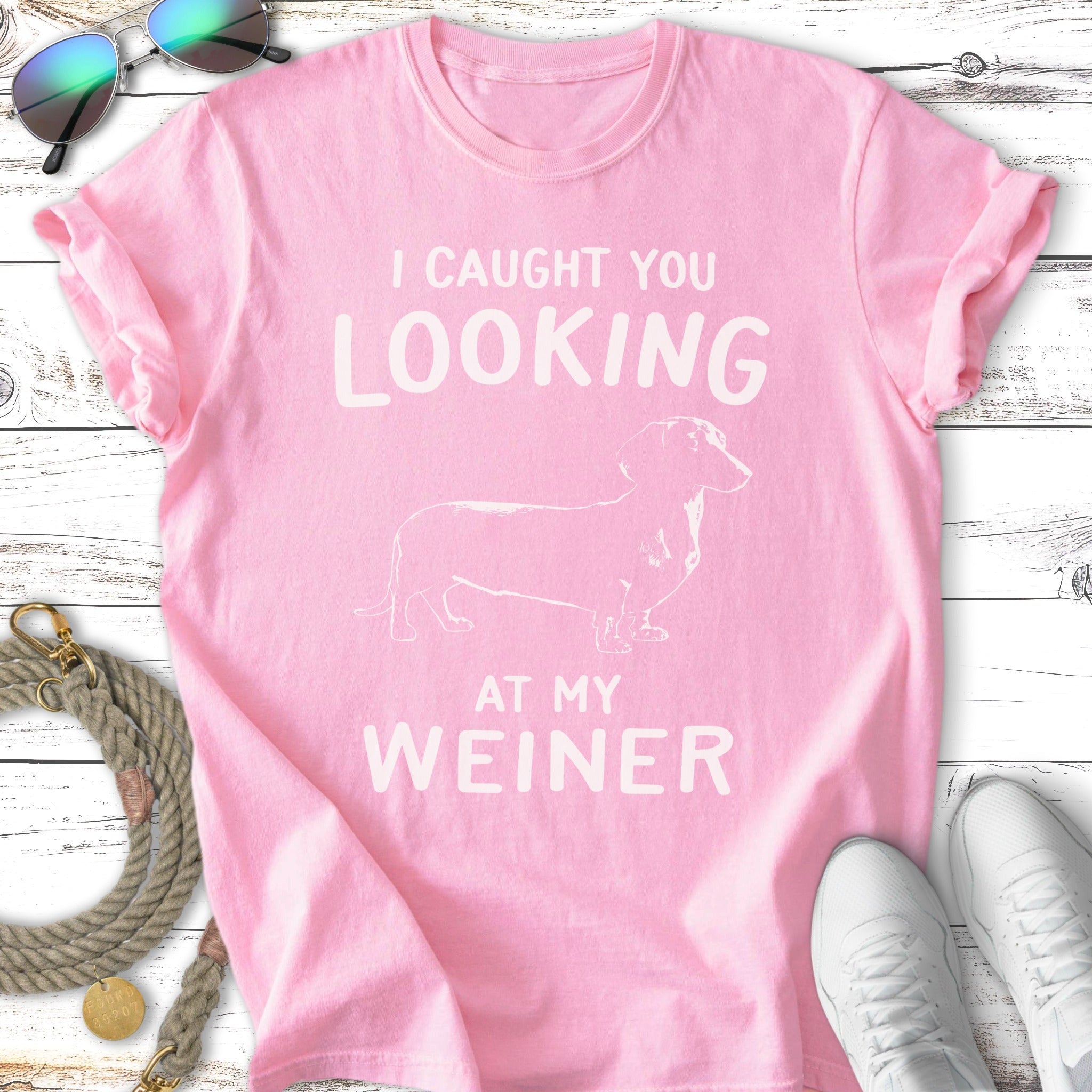 Pink t-shirt with a dachshund graphic and "I caught you looking at my weiner" text.