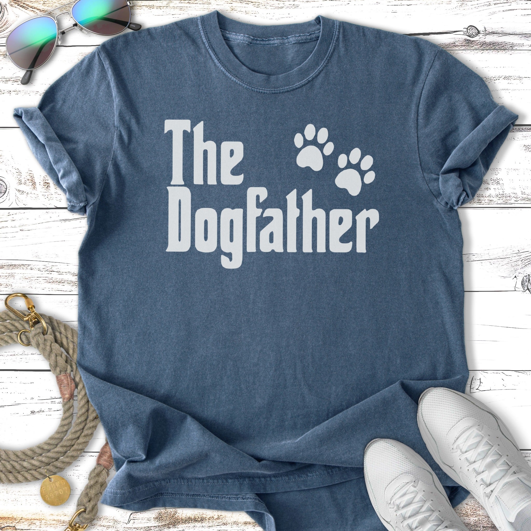 Blue t-shirt with "The Dogfather" text and paw prints.