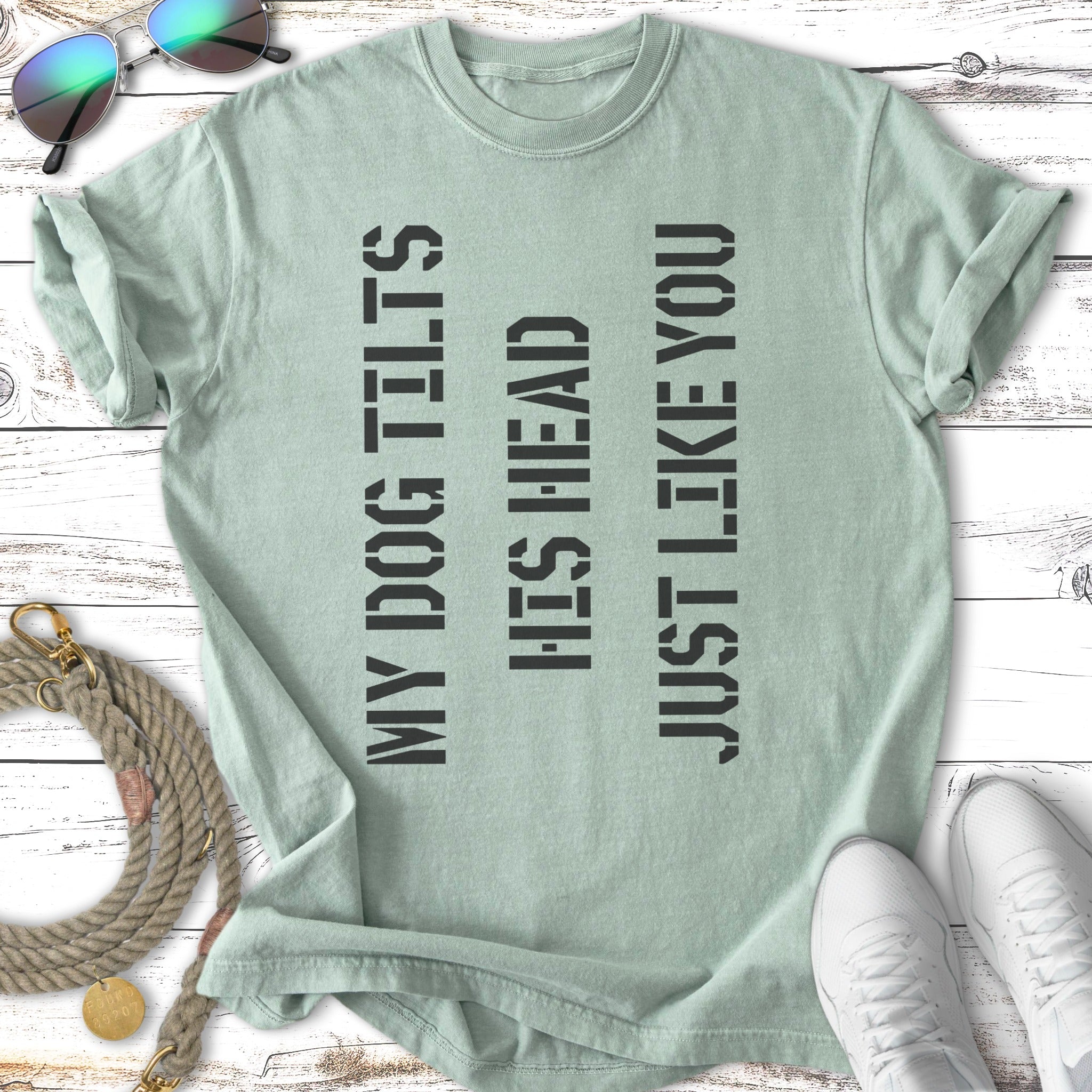 Green t-shirt with text "MY DOG TILTS HIS HEAD JUST LIKE YOU".