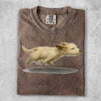 T-shirt with graphic of a running cream-colored puppy.