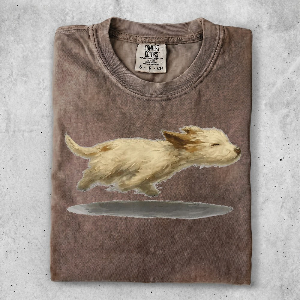T-shirt with graphic of a running cream-colored puppy.