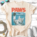 Cat reaching up from water with "PAWS" text above.