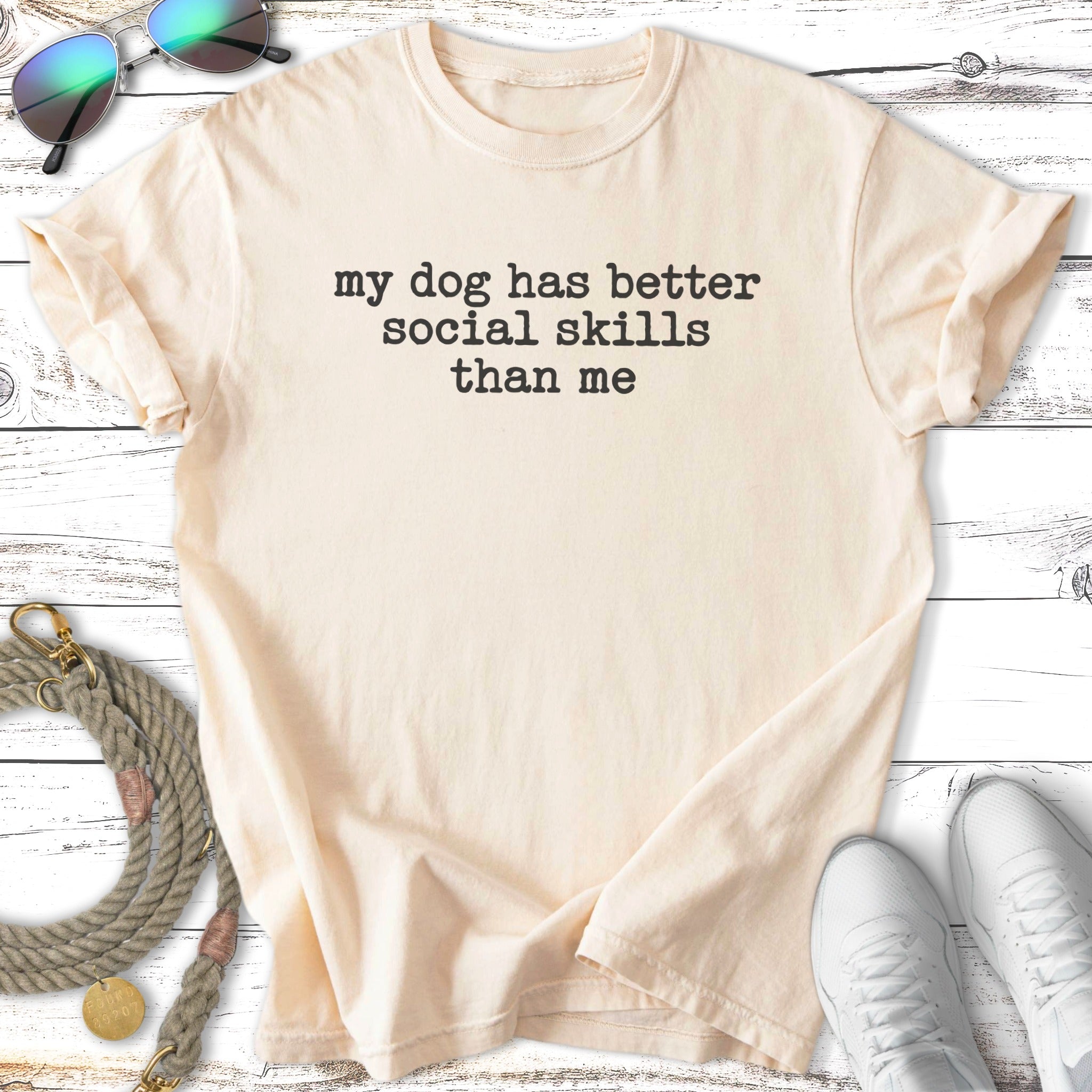 Cream t-shirt with text "my dog has better social skills than me."