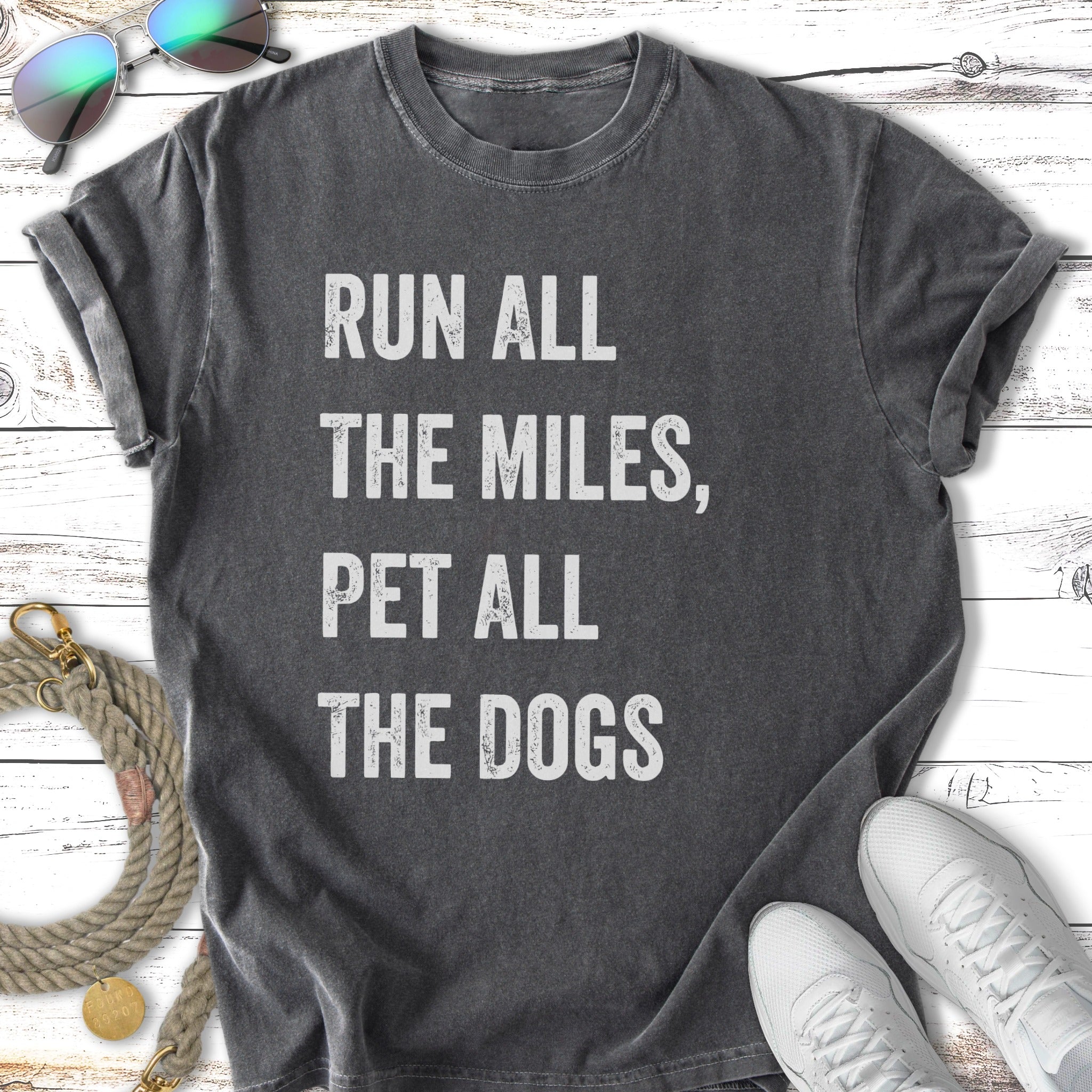 Dark gray t-shirt with "Run All The Miles, Pet All The Dogs" in white text.