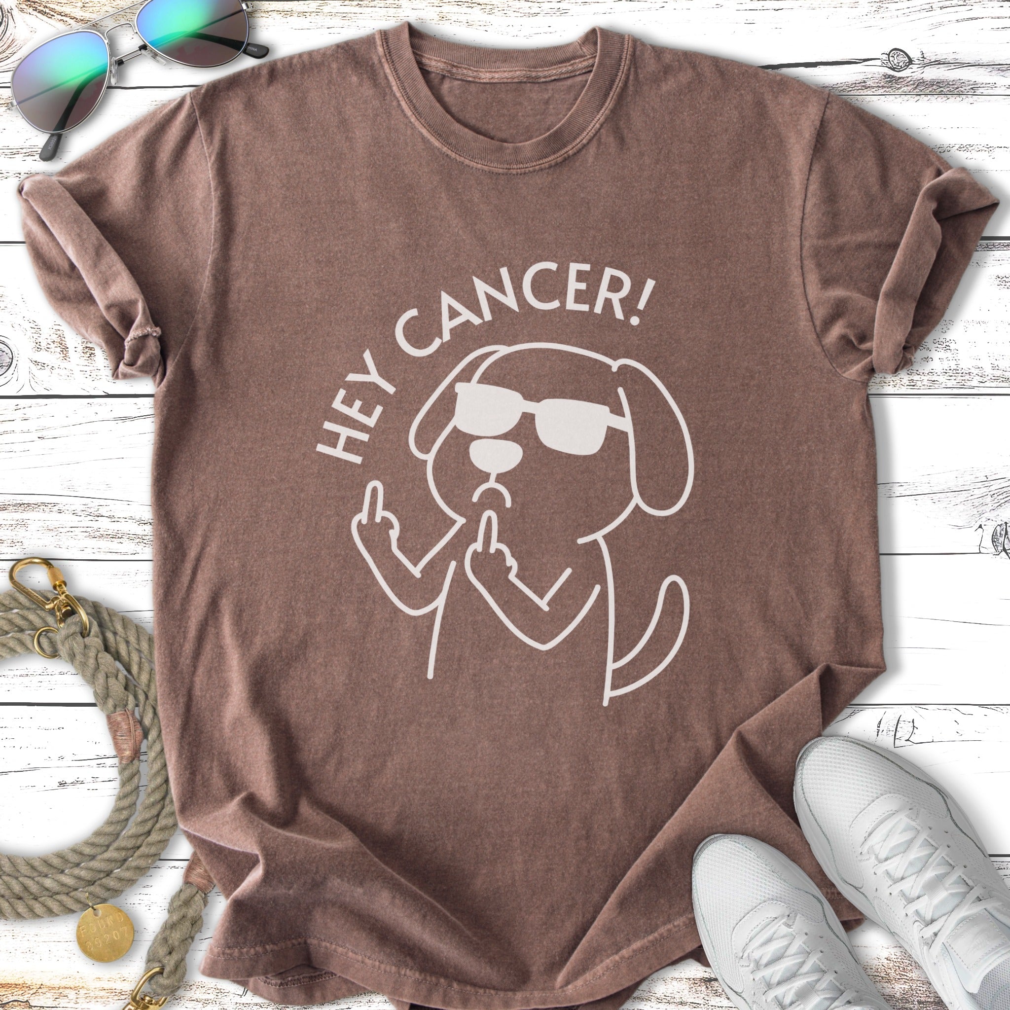 Brown t-shirt with white graphic of a dog in sunglasses flipping the bird, "Hey Cancer!" text.