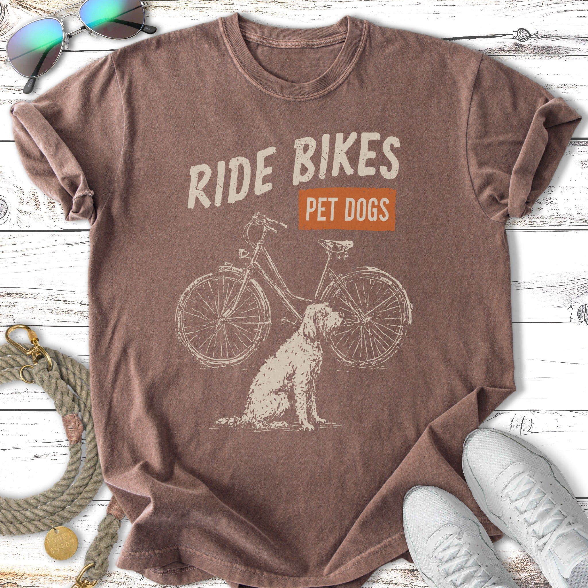 T-shirt with vintage bicycle illustration and dog, reads "Ride Bikes Pet Dogs".