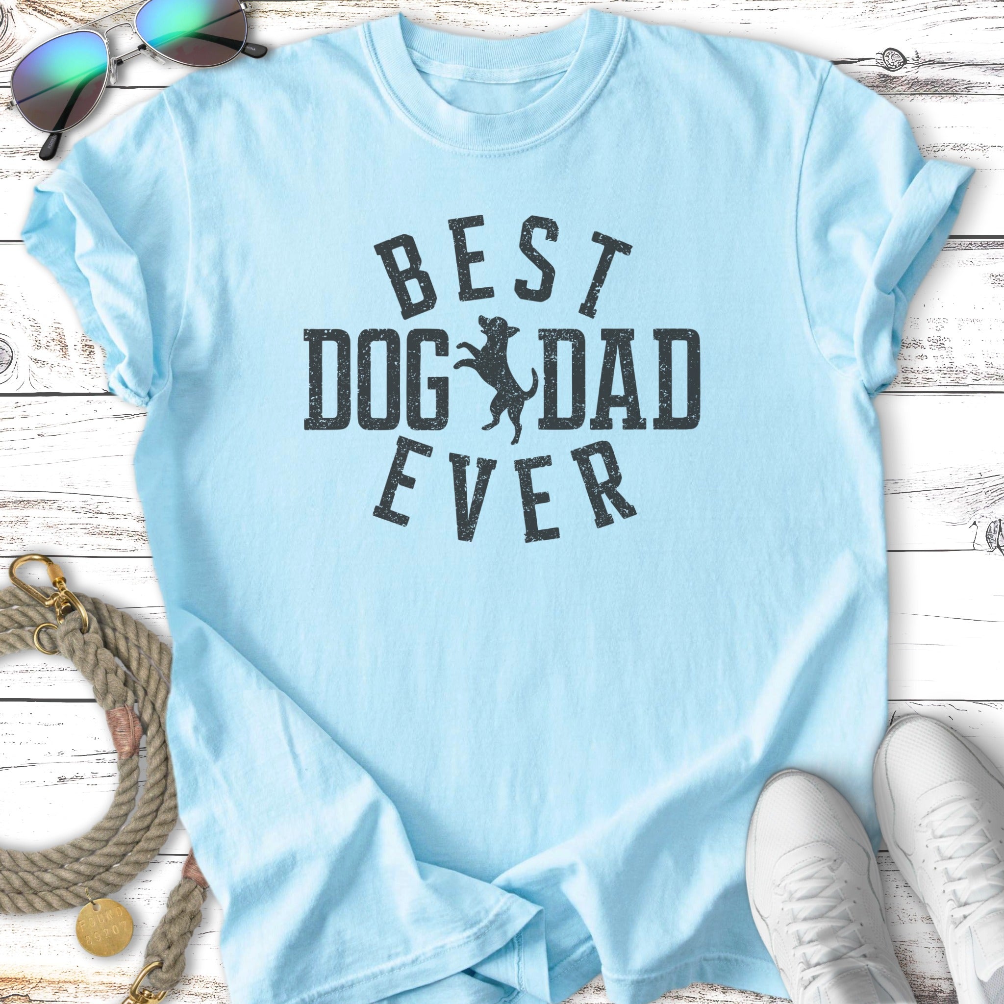Light blue t-shirt with "Best Dog Dad Ever" text and sunglasses and leash.