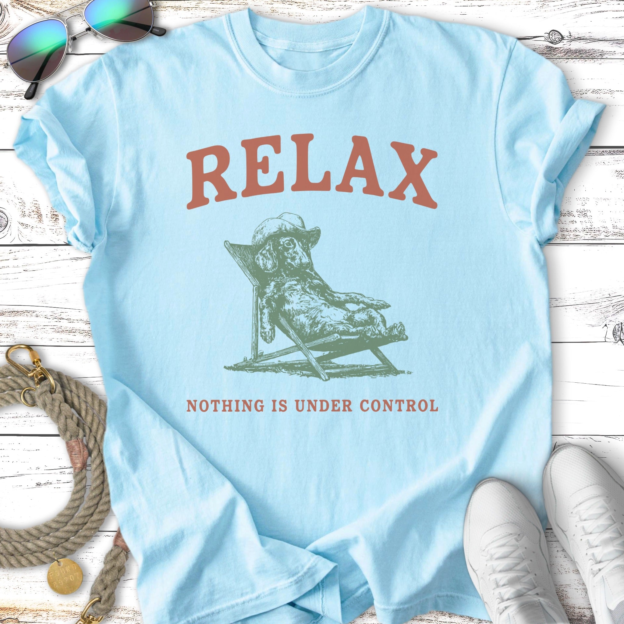 Light blue t-shirt with text "RELAX" and a dog lounging.