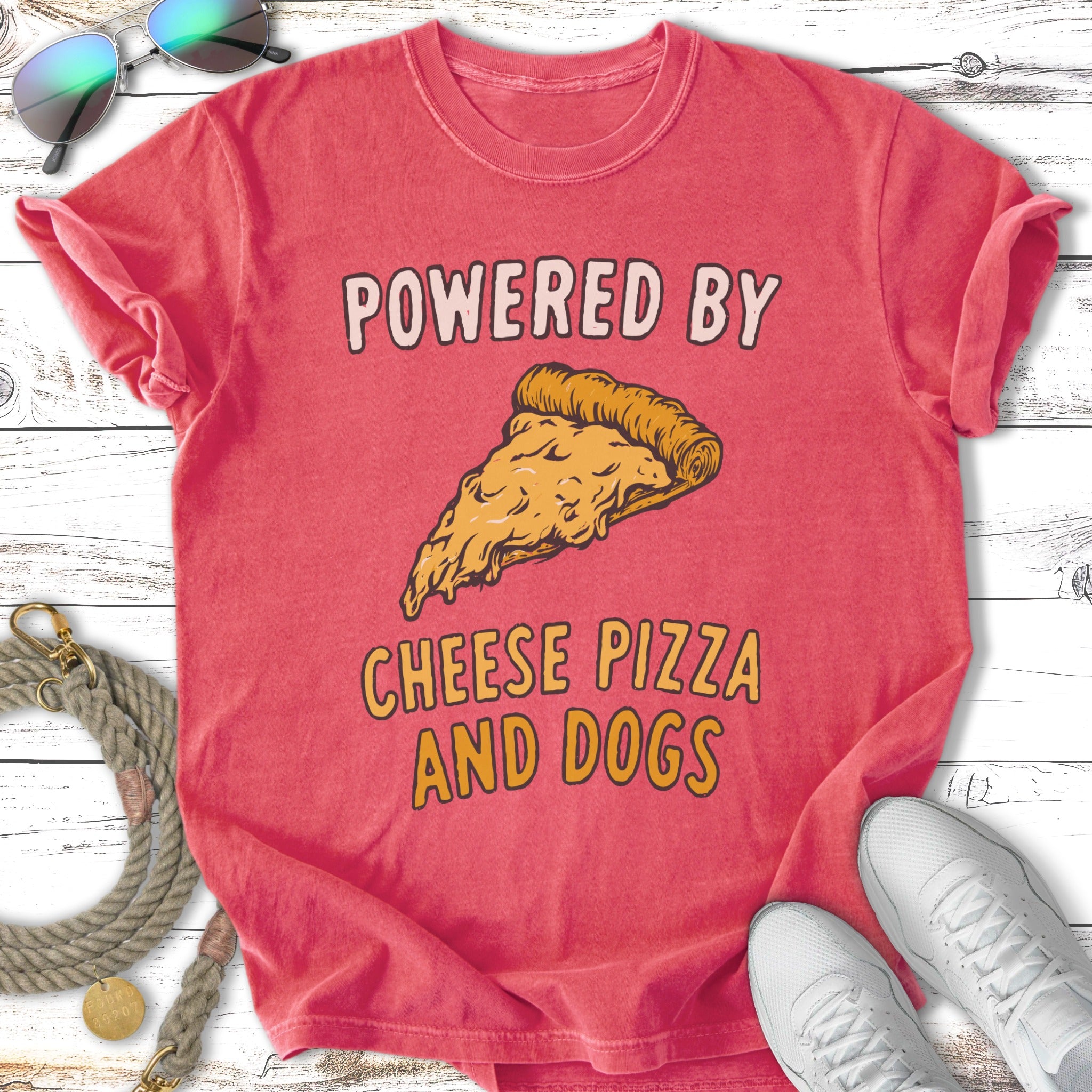 Red t-shirt with "POWERED BY CHEESE PIZZA AND DOGS" text and pizza slice graphic.