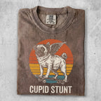 Pug with wings on a skateboard, vintage sunset, "CUPID STUNT" text.