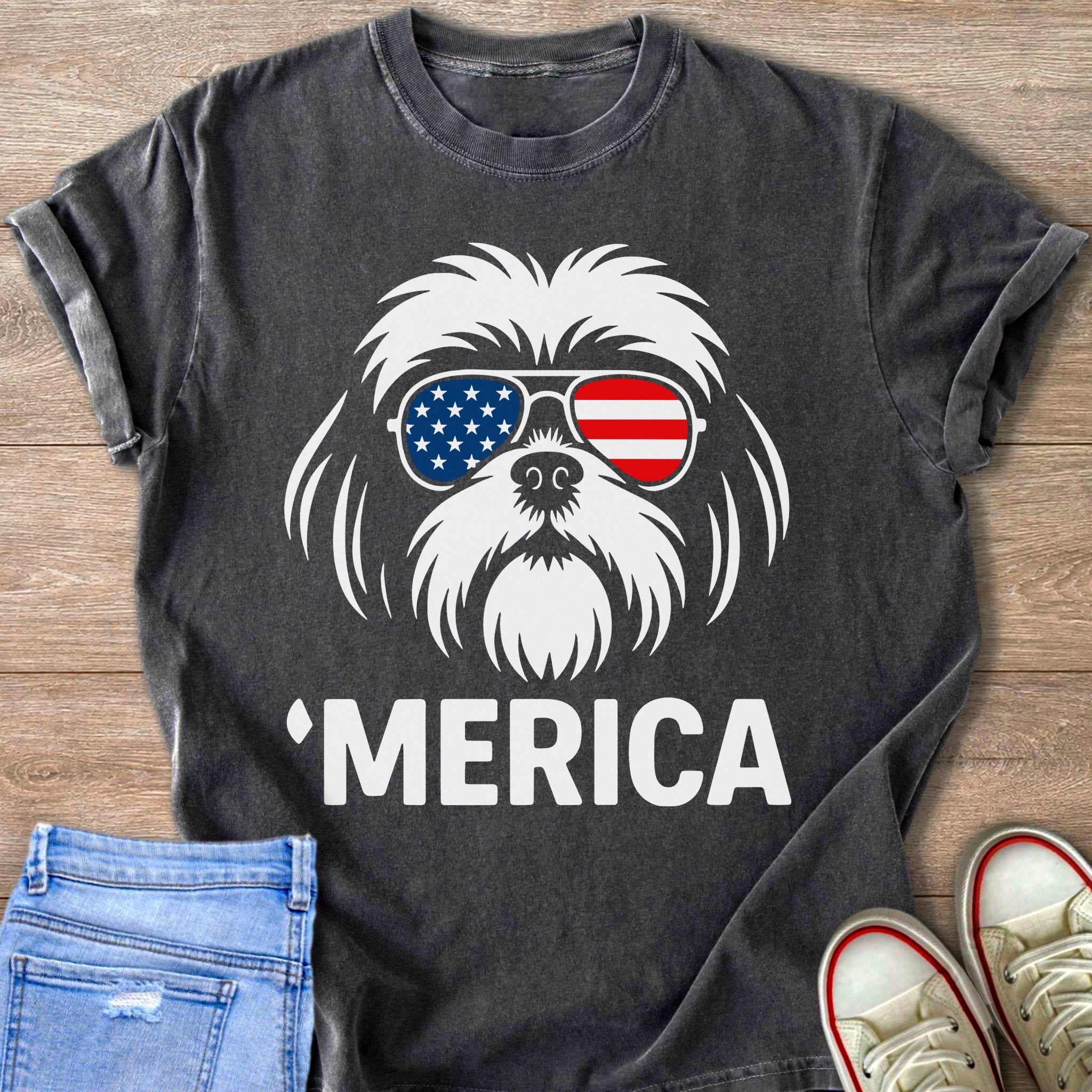 Dark t-shirt with white graphic of a dog wearing American flag sunglasses and text 'Merica.