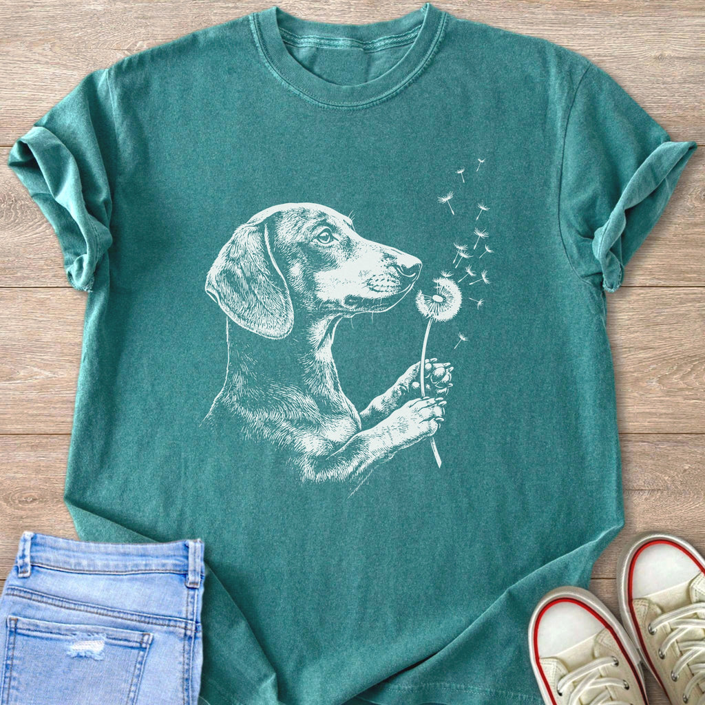 Teal t-shirt with white dachshund and dandelion illustration.