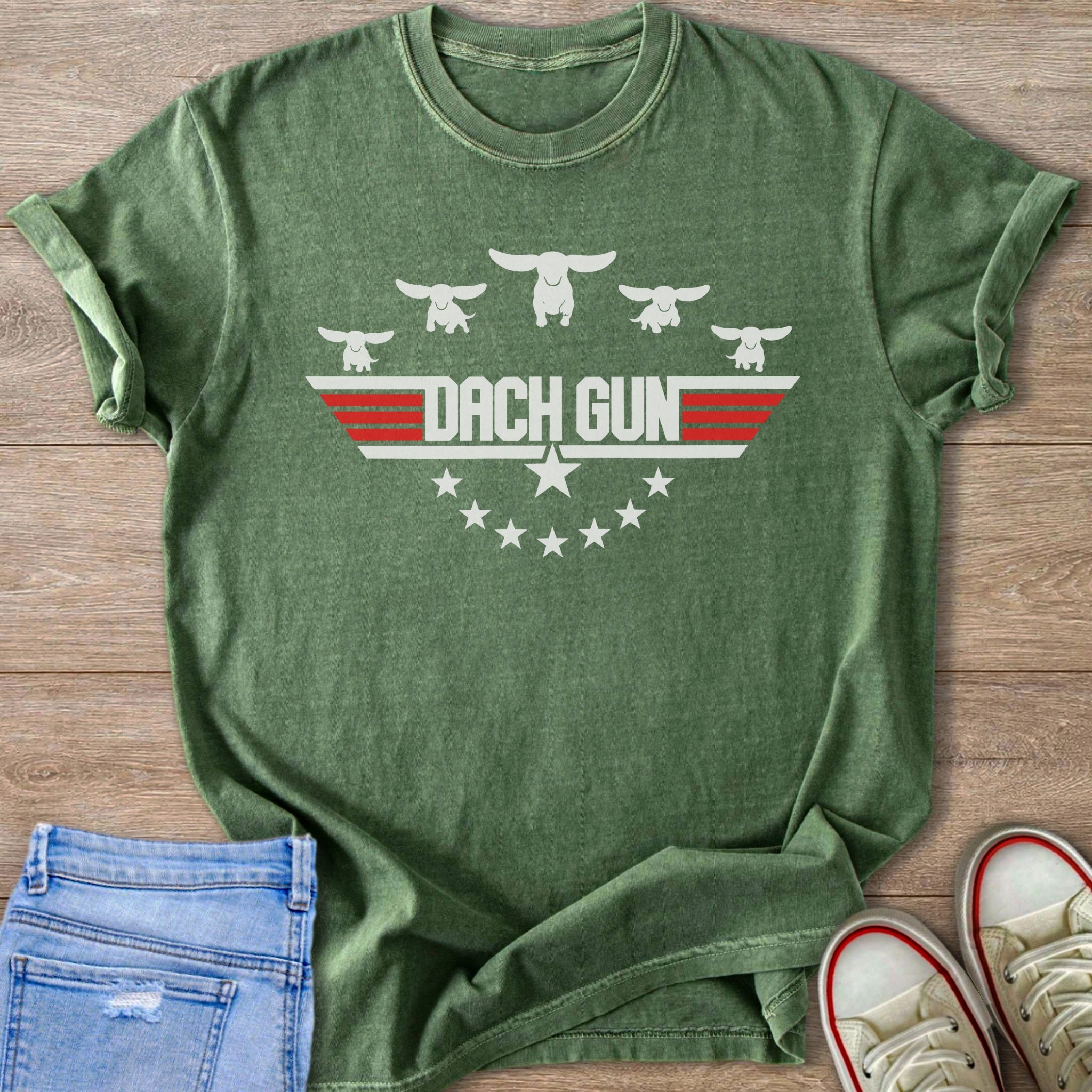 Green t-shirt with white dachshund graphics and "DACH GUN" text above stars.