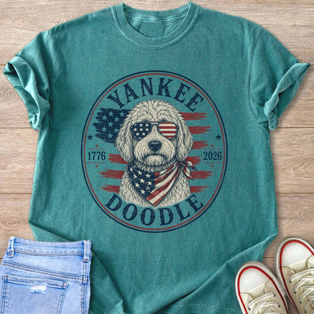 Teal t-shirt with a doodle wearing sunglasses and bandana with American flag design.