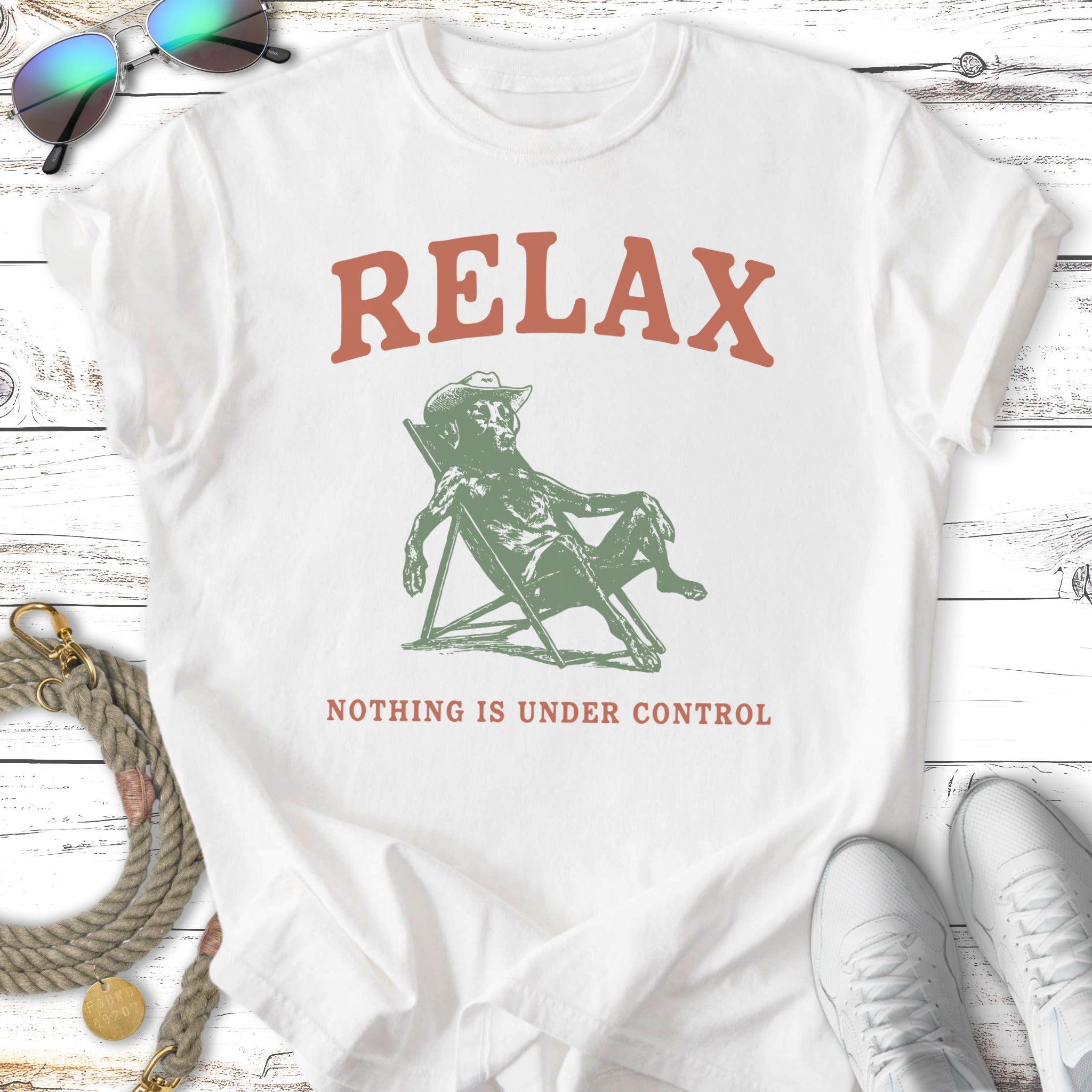 T-shirt with "RELAX NOTHING IS UNDER CONTROL" text and figure relaxing in a chair.
