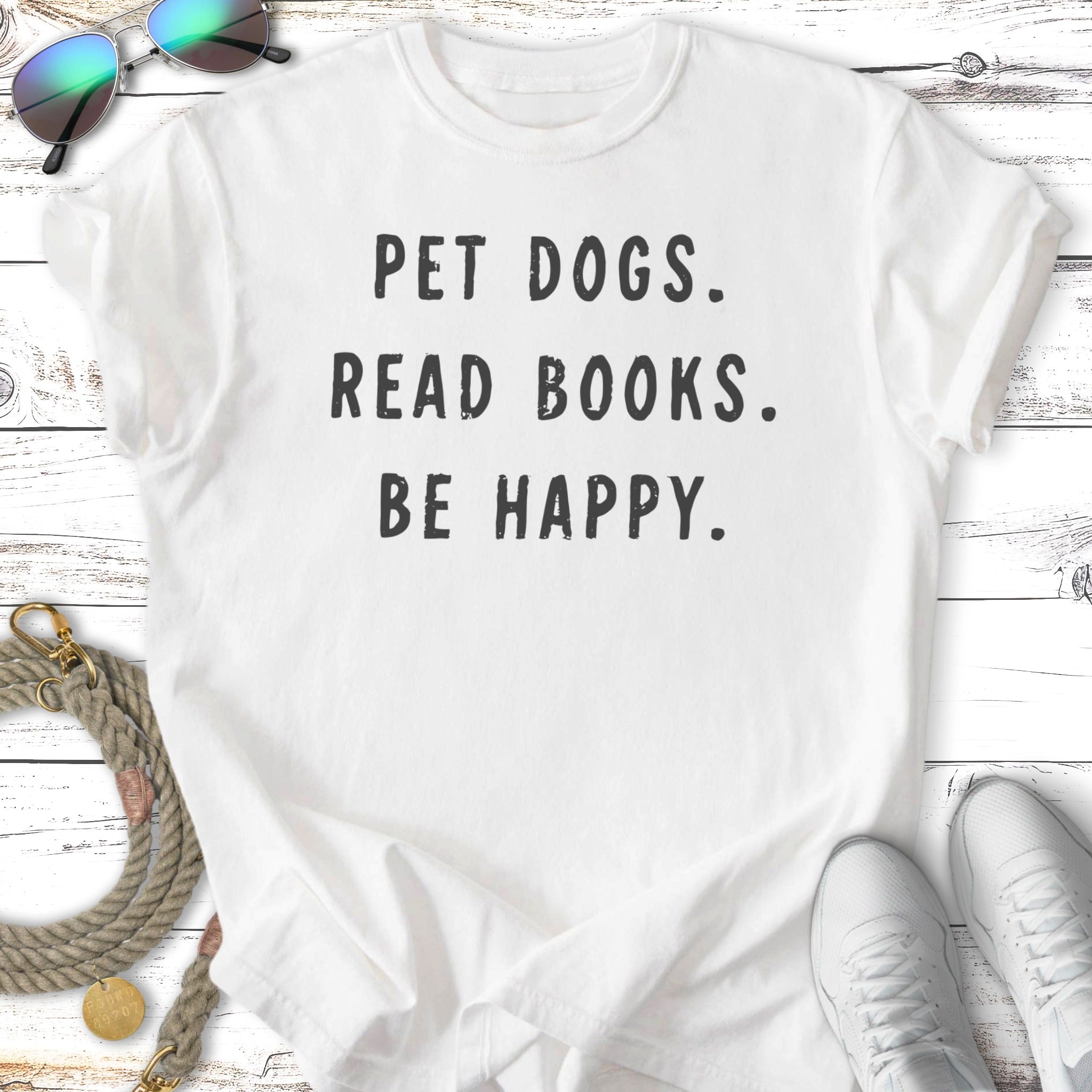 White t-shirt with "PET DOGS. READ BOOKS. BE HAPPY." text.