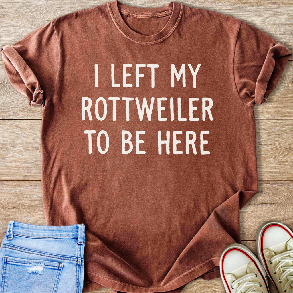 Brown t-shirt with white text "I LEFT MY ROTTWEILER TO BE HERE".