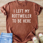 Brown t-shirt with white text "I LEFT MY ROTTWEILER TO BE HERE".