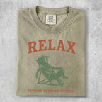 T-shirt with "RELAX" and person relaxing in chair graphics.