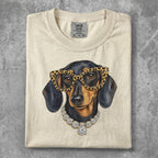 Dachshund wearing leopard print glasses and diamond necklace.