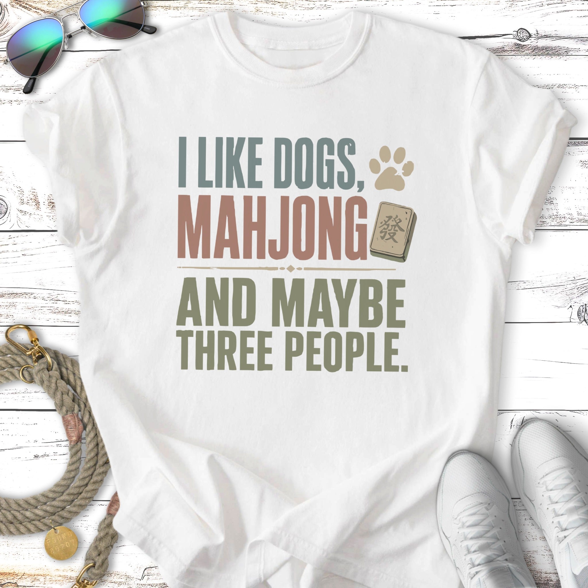 White t-shirt with "I like dogs, mahjong and maybe three people" text.