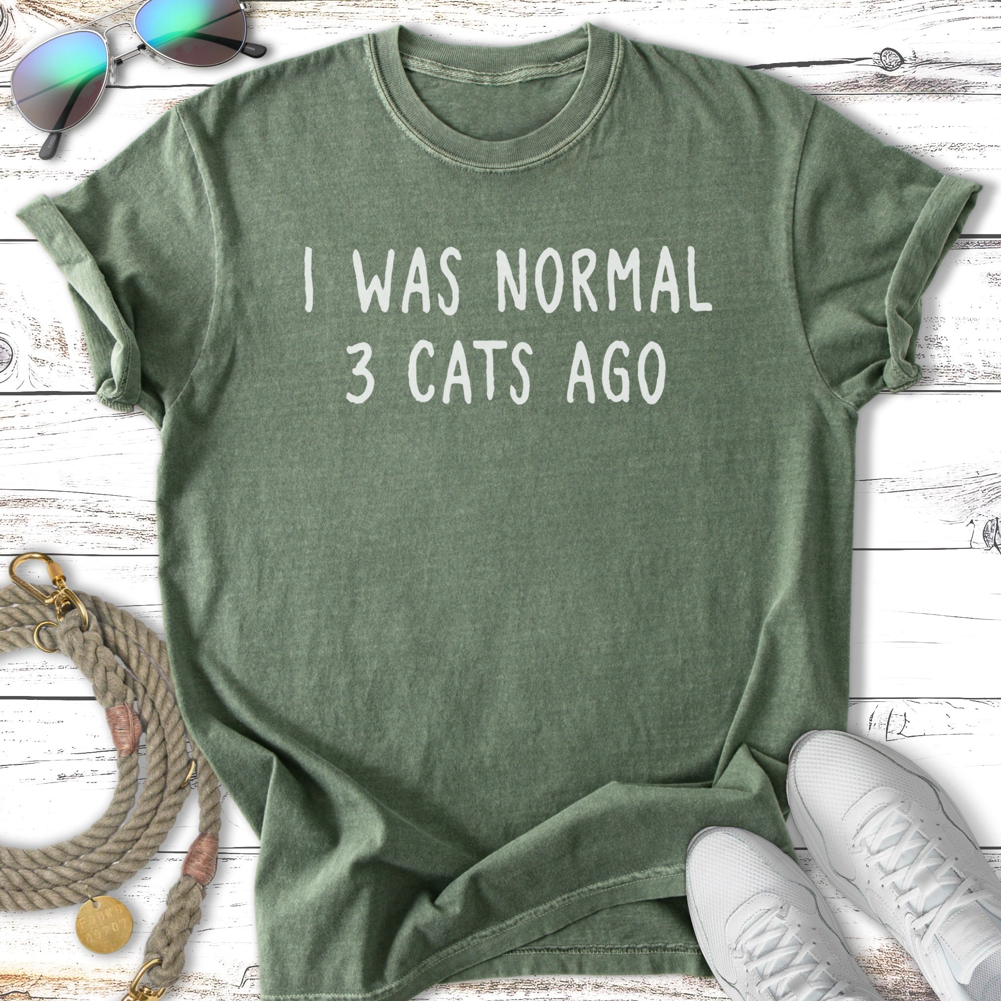 Green t-shirt with white text "I WAS NORMAL 3 CATS AGO".