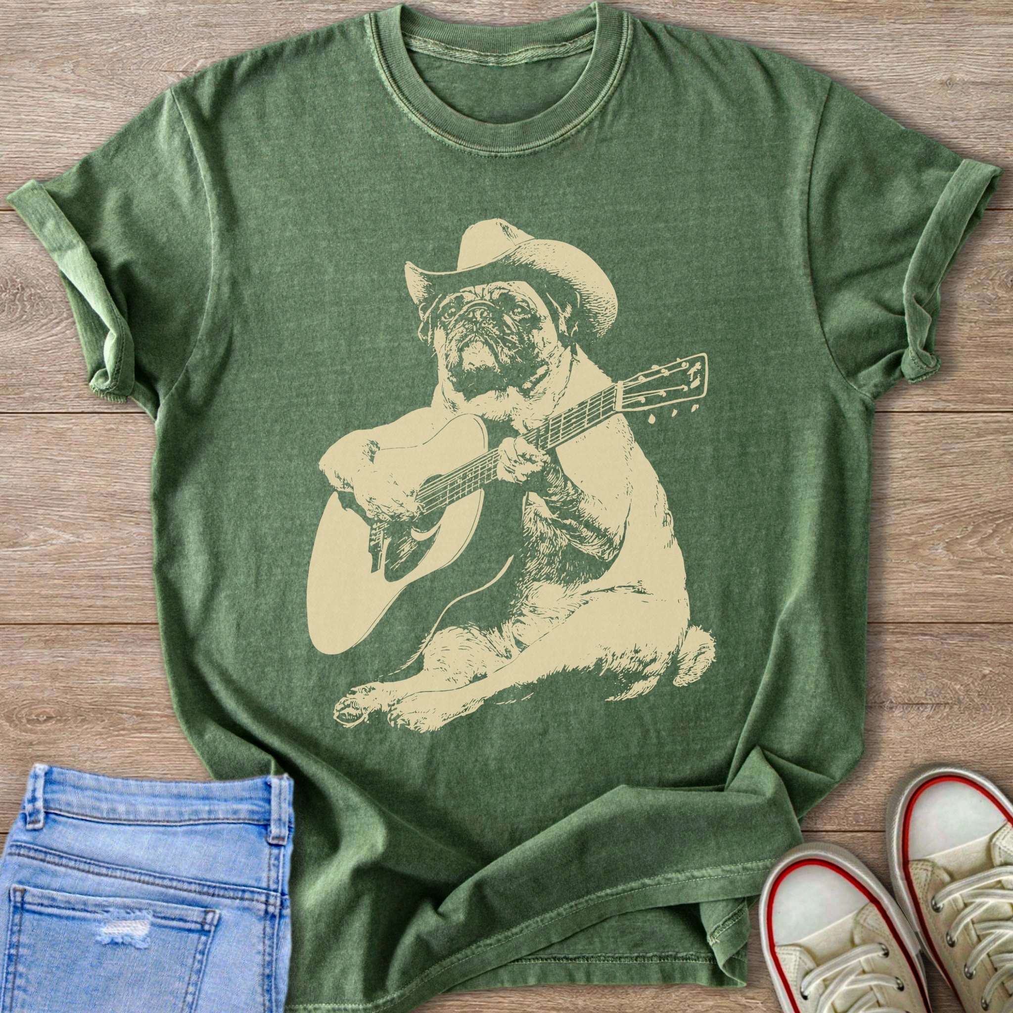 Green t-shirt with a pug wearing a cowboy hat playing a guitar graphic.