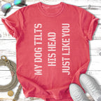 Coral t-shirt with vertical text "MY DOG TILTS HIS HEAD JUST LIKE YOU".
