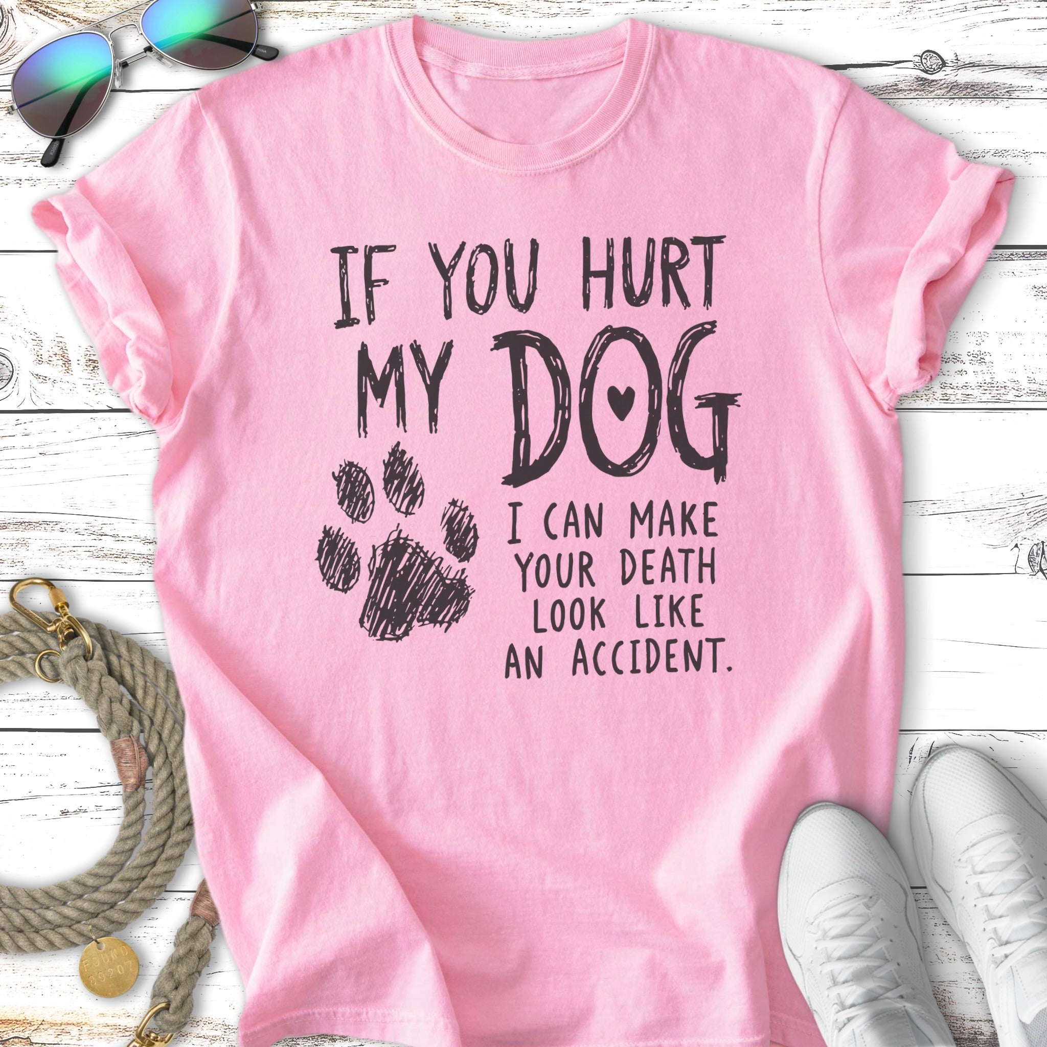 Pink t-shirt with paw print and text: "If you hurt my dog I can make your death look like an accident."