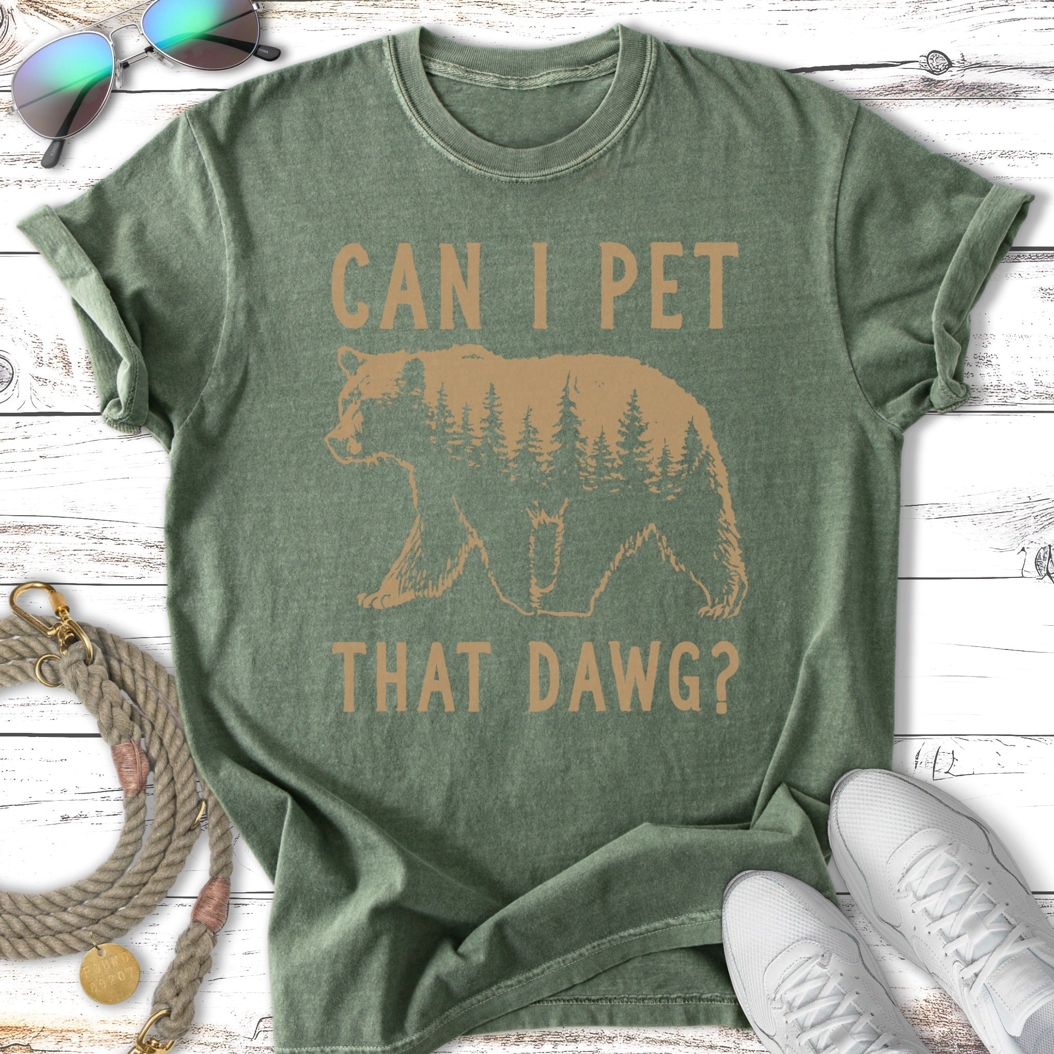 Green t-shirt with "CAN I PET THAT DAWG?" and a bear silhouette within a forest.