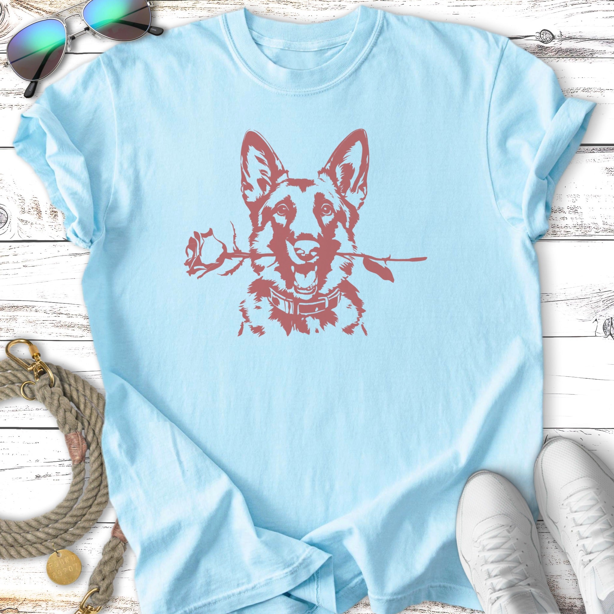 Light blue t-shirt with a maroon German Shepherd holding a rose in its mouth.