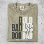 Light tan t-shirt with "BOLD BADASS DOG DAD that's just who I am!" text.