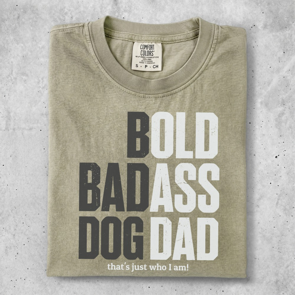 Light tan t-shirt with "BOLD BADASS DOG DAD that's just who I am!" text.