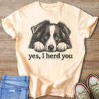 Peach t-shirt with black and white dog illustration and text "yes, I herd you".