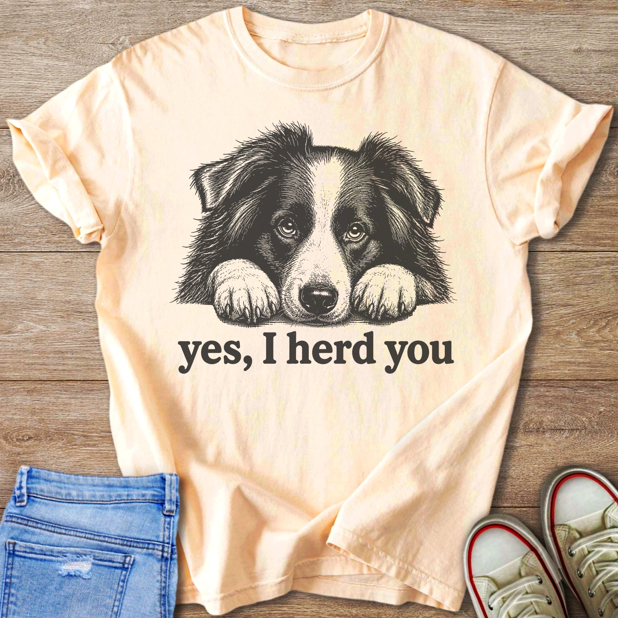 Peach t-shirt with black and white dog illustration and text "yes, I herd you".