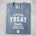 Blue Comfort Colors t-shirt with "Certified Treat Dealer" and paw print graphic.