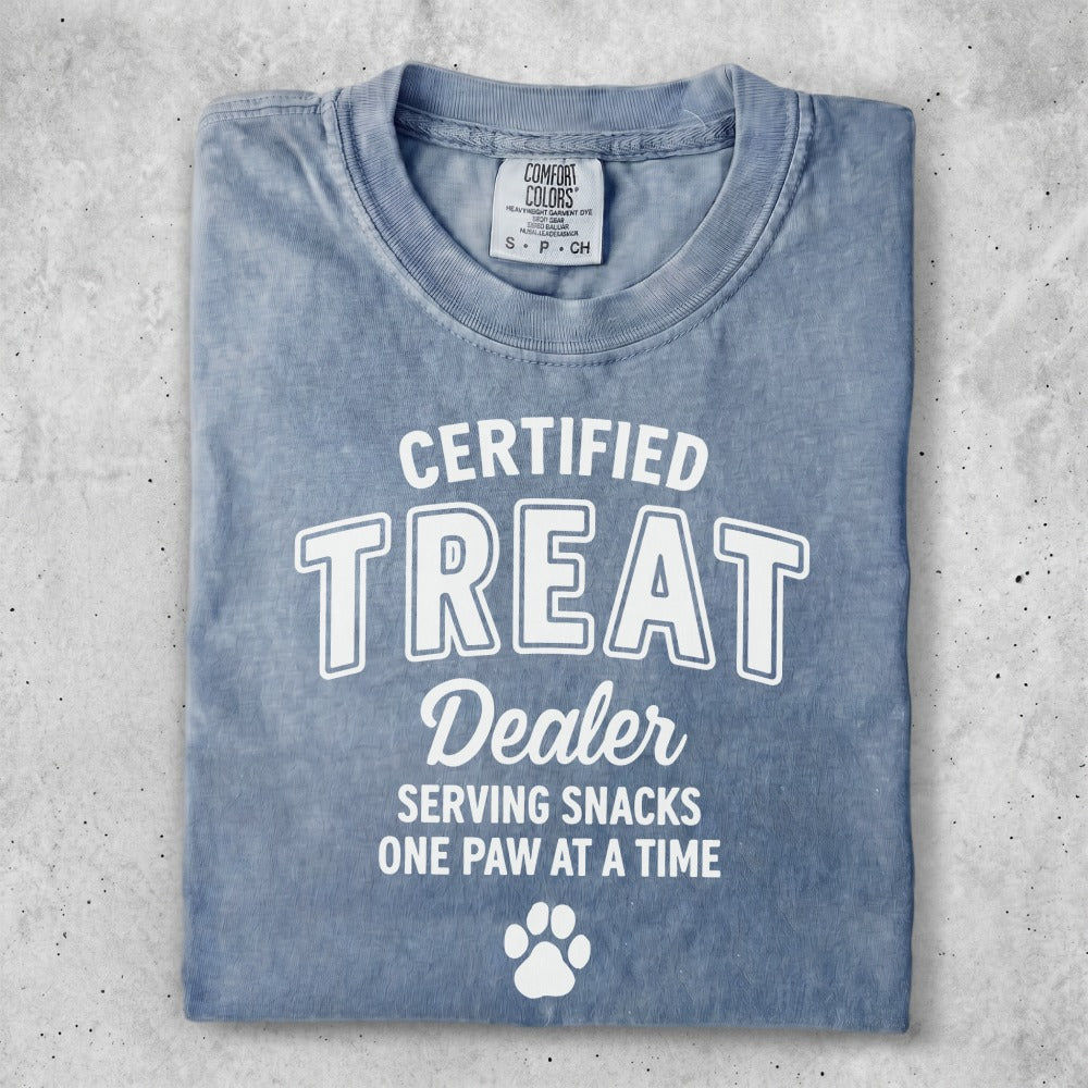 Blue Comfort Colors t-shirt with "Certified Treat Dealer" and paw print graphic.