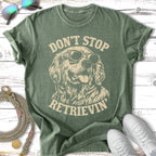 Green t-shirt with a golden retriever wearing sunglasses and the text "Don't Stop Retrieving".