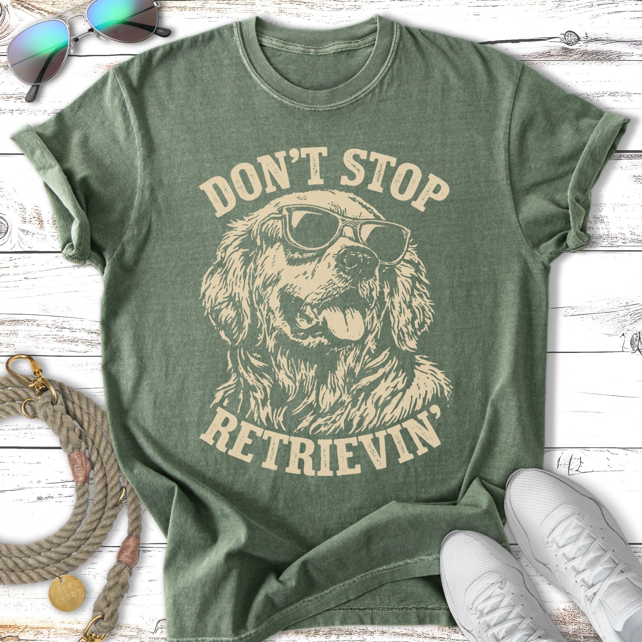 Green t-shirt with a golden retriever wearing sunglasses and the text "Don't Stop Retrieving".