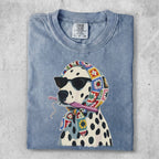 Dalmatian wearing sunglasses and a crochet scarf, holding yarn and a crochet hook.