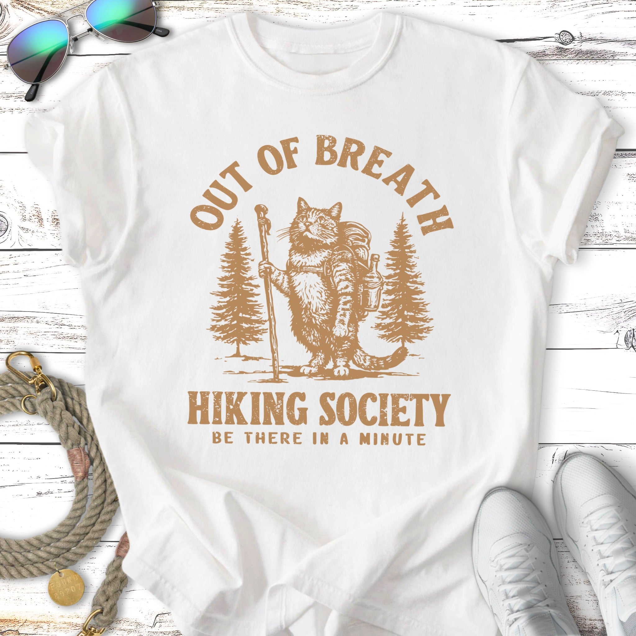Cat with backpack and walking stick on a mountain hike, "Out of Breath Hiking Society" text.