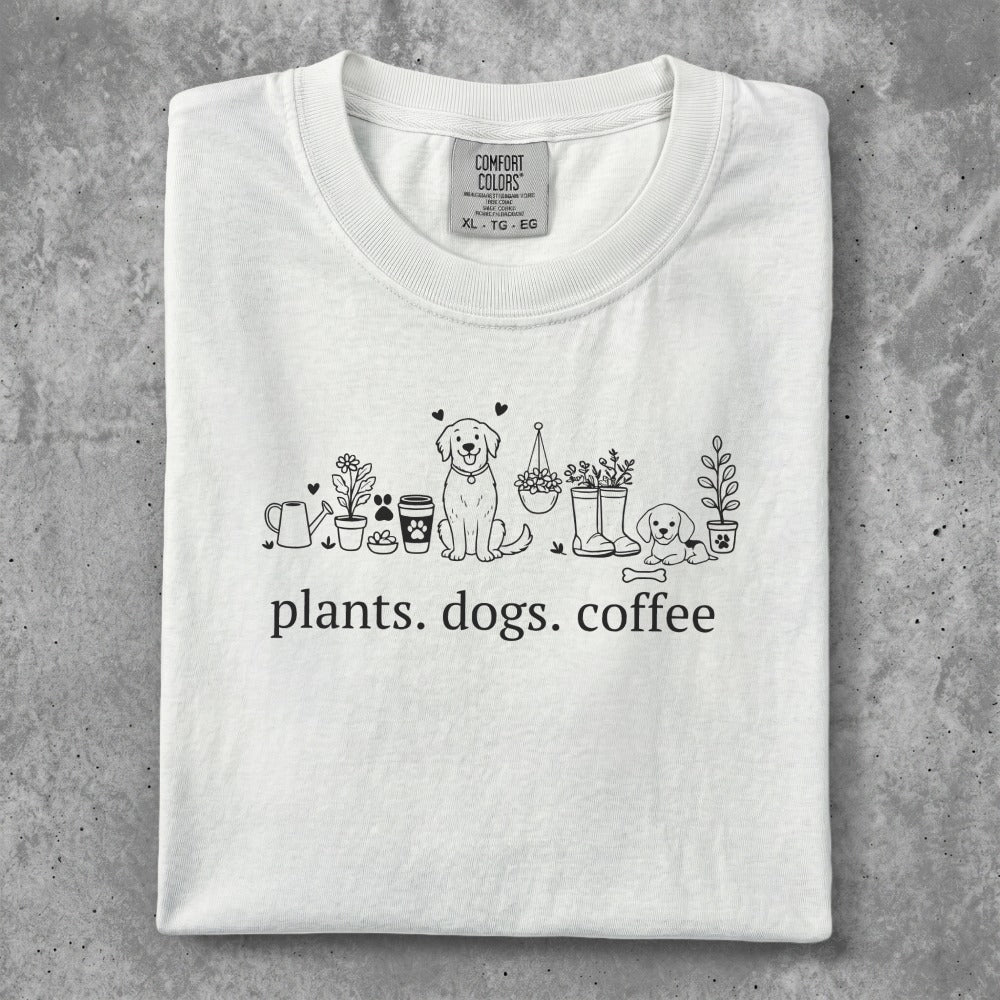 White t-shirt with "plants. dogs. coffee." text and line art.