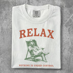White t-shirt with "RELAX" and a dog in a chair.